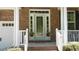 Close-up of the front porch, featuring decorative plants and a view of the entry door at 106 N Duelling Oaks Dr, Chapel Hill, NC 27517