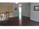 Bright hallway with hardwood floors, white trim, and decorative wall art provides a welcoming transition between living spaces at 106 N Duelling Oaks Dr, Chapel Hill, NC 27517
