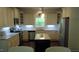 Open kitchen with stainless appliances, granite counters, tile backsplash, island, and bright natural light at 106 N Duelling Oaks Dr, Chapel Hill, NC 27517