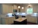 Bright kitchen featuring granite countertops, stainless steel appliances, and a central island at 106 N Duelling Oaks Dr, Chapel Hill, NC 27517