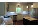 Bright kitchen with white cabinets, granite countertops, stainless steel appliances, and central island at 106 N Duelling Oaks Dr, Chapel Hill, NC 27517