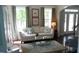 Comfortable living room featuring large windows, neutral decor and hardwood flooring at 106 N Duelling Oaks Dr, Chapel Hill, NC 27517