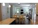 Open-concept living room featuring a fireplace, large windows, and seamless flow to the kitchen at 106 N Duelling Oaks Dr, Chapel Hill, NC 27517