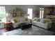 Living room showcasing ample seating, hardwood floors, and access to the kitchen at 106 N Duelling Oaks Dr, Chapel Hill, NC 27517