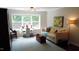Cozy living room with large window, plush sofa, and colorful accents at 106 N Duelling Oaks Dr, Chapel Hill, NC 27517