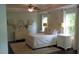 Elegant main bedroom featuring a queen bed, dresser with oval mirror and bright recessed lights at 106 N Duelling Oaks Dr, Chapel Hill, NC 27517