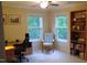 Inviting office space with two large windows, a bookshelf, and comfortable seating at 106 N Duelling Oaks Dr, Chapel Hill, NC 27517