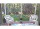 Inviting screened porch with comfortable seating and serene garden views at 106 N Duelling Oaks Dr, Chapel Hill, NC 27517