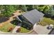 Aerial view of a single-Gathering home with well-maintained landscaping, gray roof, and attached garage at 109 Rustler Rd, Louisburg, NC 27549