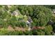 Aerial view of home nestled in a lush green forest with neighboring homes at 109 Rustler Rd, Louisburg, NC 27549