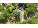 Bird's eye view of a home with large garage, long driveway, and surrounded by mature trees at 109 Rustler Rd, Louisburg, NC 27549