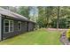 Well-maintained backyard featuring a lush lawn, dark siding and white trim windows at 109 Rustler Rd, Louisburg, NC 27549