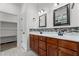 Bathroom features dual sink vanity, mosaic tile backsplash, and framed mirrors at 109 Rustler Rd, Louisburg, NC 27549