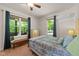 Comfortable bedroom with a bed, ceiling fan and window at 109 Rustler Rd, Louisburg, NC 27549