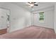 Bright bedroom with carpeted floors, ceiling fan, and natural light from the window at 109 Rustler Rd, Louisburg, NC 27549