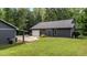 Exterior view of home with a covered parking area and attached garage in a grassy area at 109 Rustler Rd, Louisburg, NC 27549