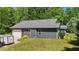 The large lawn features mature trees and shrubs, while this attached garage enhances the home's appeal at 109 Rustler Rd, Louisburg, NC 27549