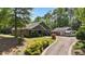 Desirable home featuring an RV garage, long driveway, and beautifully landscaped front yard at 109 Rustler Rd, Louisburg, NC 27549