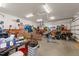 A cluttered two-car garage with an abundance of storage space, work table and lighting at 109 Rustler Rd, Louisburg, NC 27549