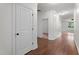 Hallway with hardwood flooring and white trim at 109 Rustler Rd, Louisburg, NC 27549