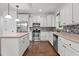 Well-equipped kitchen with an island, stainless steel appliances, and stylish backsplash at 109 Rustler Rd, Louisburg, NC 27549