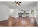 Open-concept kitchen with white cabinets, stainless steel appliances, and hardwood floors at 109 Rustler Rd, Louisburg, NC 27549