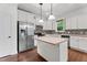 Bright kitchen features stainless steel appliances, white cabinetry and mosaic tile backsplash at 109 Rustler Rd, Louisburg, NC 27549