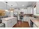 This kitchen has stainless steel appliances, white cabinets, hardwood floors and an island with barstool seating at 109 Rustler Rd, Louisburg, NC 27549