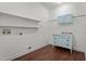 Spacious laundry room featuring hardwood floors, shelving, and stylish storage solutions at 109 Rustler Rd, Louisburg, NC 27549