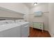 Functional laundry room with washer, dryer, and storage shelves at 109 Rustler Rd, Louisburg, NC 27549
