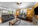 Open concept living room with hardwood floors, grey sofas and a view of the kitchen and dining room at 109 Rustler Rd, Louisburg, NC 27549
