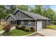 Rear exterior view of the house featuring a attached garage and well-maintained landscaping at 109 Rustler Rd, Louisburg, NC 27549