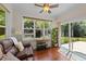Bright sun room features a ceiling fan, hardwood floors and a sliding glass door that leads to the backyard at 109 Rustler Rd, Louisburg, NC 27549