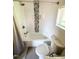 A bright bathroom features a tub with shower, decorative tiles, and a white toilet at 1100 Chester St, Durham, NC 27701