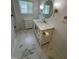 Updated bathroom with modern fixtures, marble floors, cabinet, and stylish mirror at 1100 Chester St, Durham, NC 27701