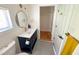 Bathroom with a sink vanity, tile flooring, and a large mirror and a separate doorway to a closet at 1100 Chester St, Durham, NC 27701