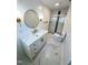 Bright bathroom features white marble floors, vanity with marble countertop, and updated glass enclosed shower at 1100 Chester St, Durham, NC 27701