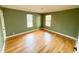 Bedroom with wood floors, neutral color scheme, and plenty of natural light from the windows at 1100 Chester St, Durham, NC 27701