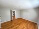 Bedroom with wood floors and a nearby laundry closet at 1100 Chester St, Durham, NC 27701