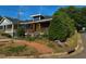 Charming home showcasing a vivid yellow door, complemented by a welcoming wooden porch and appealing blue siding at 1100 Chester St, Durham, NC 27701