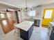 Bright kitchen features a marble tile floor, island, and stainless steel appliances at 1100 Chester St, Durham, NC 27701