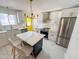 Modern kitchen featuring a stylish island with seating, stainless steel appliances, and elegant white cabinetry at 1100 Chester St, Durham, NC 27701