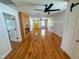 Spacious living room with hardwood floors, updated white doors, and a wood accent wall at 1100 Chester St, Durham, NC 27701