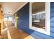 Inviting front porch showcasing a vibrant yellow door, complemented by stylish light fixtures and a cozy welcome mat at 1100 Chester St, Durham, NC 27701