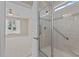 Bathroom showcasing glass shower with a seat and safety bar and view of bedroom at 115 Moss Creek Pl, Fuquay Varina, NC 27526