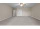 Spacious carpeted bedroom featuring a ceiling fan and ample closet space at 115 Moss Creek Pl, Fuquay Varina, NC 27526