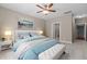 Serene bedroom with plush carpeting, ceiling fan, and an ensuite bathroom entrance at 115 Moss Creek Pl, Fuquay Varina, NC 27526