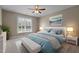 Bright bedroom featuring soft carpeting, natural light, and contemporary furnishings at 115 Moss Creek Pl, Fuquay Varina, NC 27526