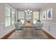 Elegant dining room with ample natural light, modern chandelier, and stylish decor at 115 Moss Creek Pl, Fuquay Varina, NC 27526