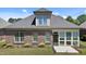 Rear exterior view of a brick home and patio at 115 Moss Creek Pl, Fuquay Varina, NC 27526